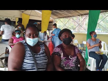 Aneika James and her 67-year-old mother Novlette James celebrate receiving the first dose of the COVID-19 vaccine during the blitz held Saturday at the Denbigh Agricultural Showground in May Pen, Clarendon.