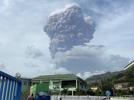 A plume of ash rises in the air and is seen from Kingstown, the capital of St Vincent and the Grenadines, on Friday. 
