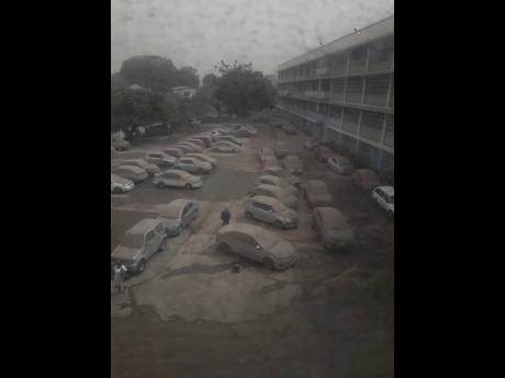 The car park at the Queen Elizabeth Hospital in Bridgetown, Barbados, is covered in ash and dust blown from the Soufriere Volcano.