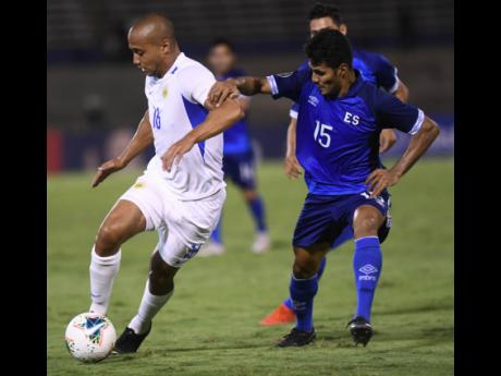 Curacao’s Gino Van Kessel (left) takes the ball while under pressure from El Salvador’s Jonathan Jiminez in their Concacaf Gold Cup encounter at the National Stadium in 2019.
