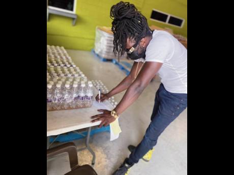 Skinny Fabulous checks off the water stock at one of the collection sites in St Vincent. Water is one of the greatest needs in St Vincent and the Grenadines as the natural resource has been contaminated with volcanic ash.
