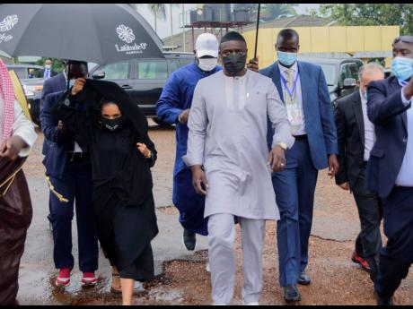Senegalese-American performer Akon (right) and his wife, Rozina, arrive at the Gaddafi National mosque, in Kampala, Uganda, on Friday. Akon is visiting Uganda in search of investment opportunities that would extend his business footprint in Africa, where h