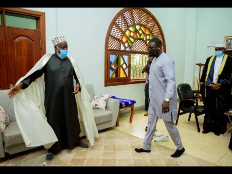 Akon (right) is welcomed by the Mufti of Uganda, Shiekh Shaban Mubajje, at the Gaddafi National mosque, in Kampala, Uganda.