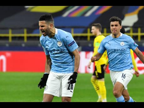 Manchester City’s Riyad Mahrez (left) celebrates after scoring his side’s first goal during the Champions League quarter-final second leg match between Borussia Dortmund and Manchester City at the Signal Iduna Park stadium in Dortmund, Germany, yesterd