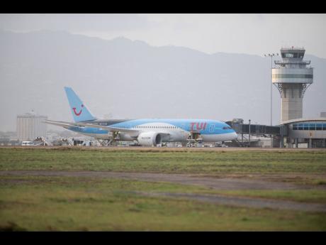 More than 100 Jamaicans, including 75 shipworkers, arrive at the Norman Manley International Airport on a TUI flight from the United Kingdom on May 6, 2020, under the watchful eye of air traffic control tower operators. The Jamaica Civil Aviation Authority