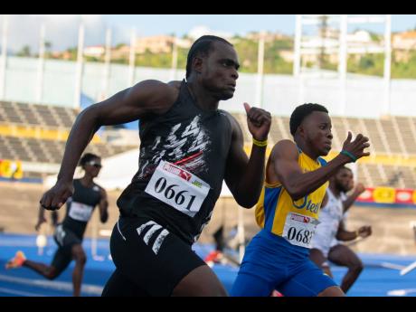 Jevaughn Minzie (left) of Titans Track Club competes in the 200m event at the Jamaica Athletics Administrative Association Qualification Trials 3.6 held at The National Stadium on March 13, 2021.
