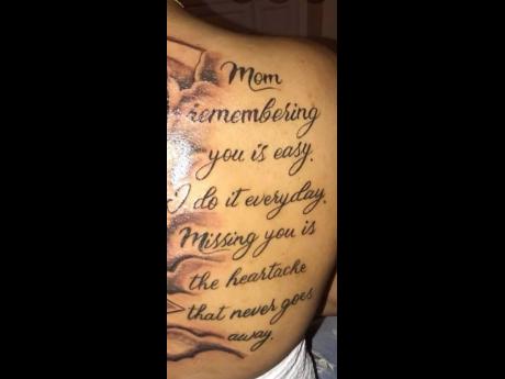 Georgia Henry shows her tattooed back on which an ode to her missing mother is etched.