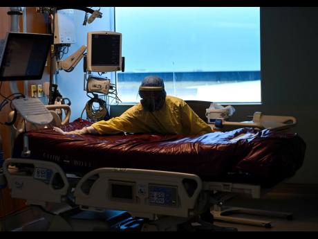 An essential worker thoroughly cleans a COVID-19 patient’s room after they were transferred out of the intensive care unit at the Humber River Hospital in Toronto on Tuesday, April 13, 2021. 