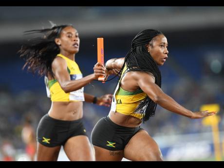 Jamaica’s Stephenie Ann McPherson (left) hands off the baton to Shelly-Ann Fraser-Pryce in the women’s 4x200m relay at the World Athletics Relay Championships in Yokohama, Japan on Sunday, May 5, 2019.