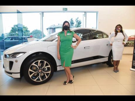Stewart’s Automotive Group Director Jacqueline Stewart-Lechler and Kim del Mondo strike up a pose beside the all-electric 2021 Jaguar I-Pace.