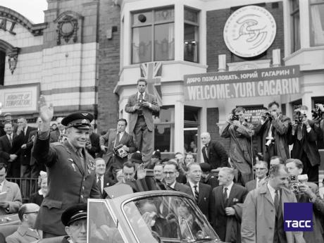 
Soviet astronaut Yuri Gagarin (left front) is greeted by a jubilant crowd as his motorcade passes through London, in July 1961. 