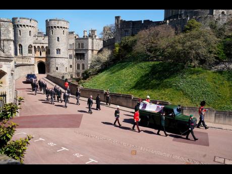 
Family members follow the coffin during a procession arriving at St George’s Chapel for the funeral of Britain’s Prince Philip inside Windsor Castle in Windsor, England, on Saturday. Prince Philip died April 9 at the age of 99 after 73 years of marria