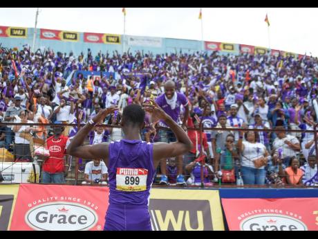 
Akeem Weir of Kingston College celebrates in front of his school’s supporters after winning the Class Three boys’ 400 metres final on the last day of the ISSA/GraceKennedy Boys and Girls’ Athletics Championships at the National Stadium on Saturday, 