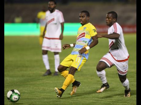 In this file photo from April 2018, then Waterhouse FC player Tremaine Stewart (left) is tracked by Portmore United's Kemar Phillpotts during their Jamaica Premier League final at the National Stadium.
