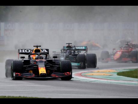 Red Bull driver Max Verstappen of the Netherlands leads Mercedes driver Lewis Hamilton of Britain and Ferrari driver Charles Leclerc of Monaco during the Emilia-Romagna Formula One Grand Prix, at the Imola racetrack in Italy yesterday.