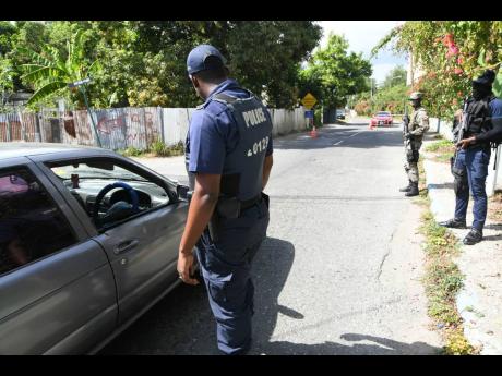 In this February 2021 photo, security personnel from the Jamaica Constabulary Force and Jamaica Defence Force are seen manning a ZOSO checkpoint in August Town. Minister of National Security Dr Horace Chang has come under fire from members of the Jamaican 
