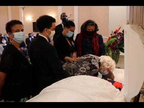 Beryl Russell, widow of Rev Dr Horace Russell, surrounded by her children, gives a farewell kiss to her husband of 63 years at a service of thanksgiving for his life at the DeBaptiste Funeral Home auditorium in Pennsylvania, USA, last Saturday. Derrick Sco