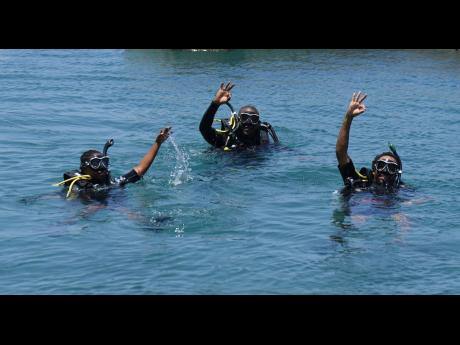 Inilek Wilmot (right), manager of the Oracabessa Bay Fish Sanctuary;  J. James (left), biology student; and Travis Graham, executive director of the Oracabessa Foundation, emerge from a dive in the seaside St Mary town.