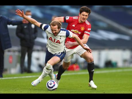 Tottenham’s Harry Kane (left) is challenged by Manchester United’s Harry Maguire during their English Premier League match at the Tottenham Hotspur Stadium in London, England on Sunday, April 11. UEFA President Aleksander Ceferin says players at the 12