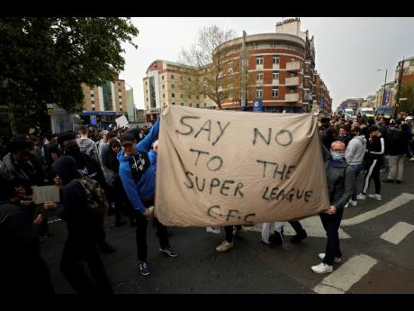 Chelsea fans protest outside Stamford Bridge stadium in London, against Chelsea's decision to be included amongst the clubs attempting to form a new European Super League, Tuesday, April 20, 2021. Reaction to the proposals from 12 clubs to rip up European 