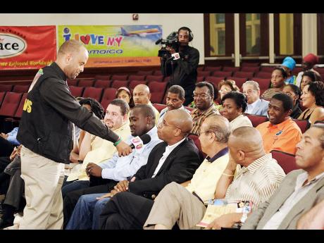Michael Sharpe (left), the host of Television Jamaica’s current affairs programme, ‘Your Issues Live’,  speaks with Marlon Hill, a member of the Jamaican Diaspora in the United States, during a taping of the programme.