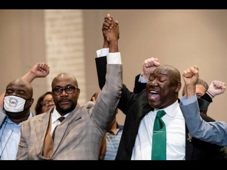 Philonise Floyd (left), brother of the late George Floyd, and attorney Ben Crump celebrate in triumph during a news conference after the murder conviction against former Minneapolis police officer Derek Chauvin on Tuesday.