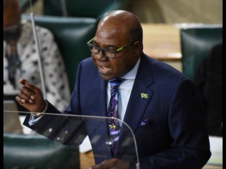 Edmund Bartlett, minister of tourism, makes his Sectoral Debate presentation during the sitting of the House of Representatives in Parliament on Tuesday.