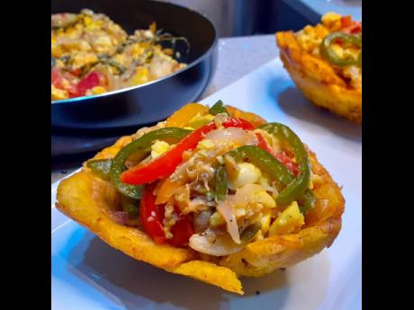 Chef Lindsay’s creative twist on the country’s national dish, ackee and salt fish, laying on a bed of deep-fried green plantain cups.