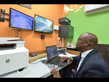 
Marvin Johnson, then acting principal of Tivoli Gardens High School in Kingston, monitors the compound via CCTV cameras to ensure safety and security. Noting the benefits of such a system, attorney-at-law Peter Champagnie believes all businesses should be