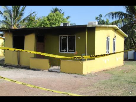 This house on Hibiscus Way in the Lionel Town Housing Scheme was firebombed on Monday morning, causing residents to become fearful. A car and house were shot up Tuesday morning on Young Street, which persons believe was a reprisal.