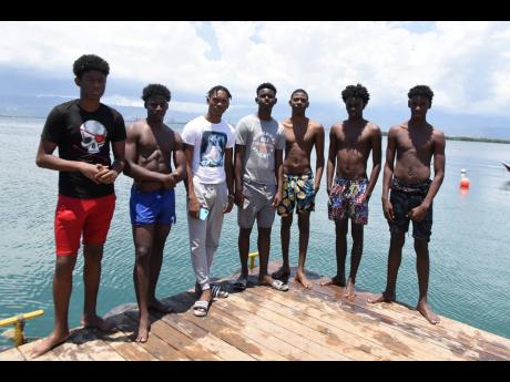 From left: Omarion Muirhead, Ronaldinho Brown, Gary Henry, Rahvear Swaby, Jhaziel Robinson, Prince Bryan, and Thadius Brown. The social-media influencers are making a splash in swimming, diving, and online gaming.