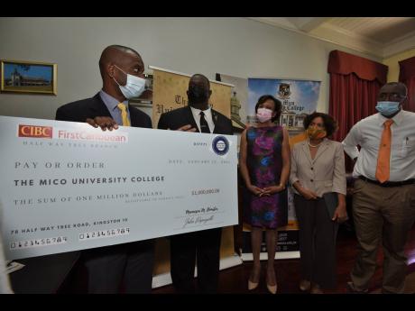 Dr Ashburn Pinnock (left), president of The Mico University College, thanks members of Mico’s Batch #146 alumni after they presented a cheque for $1 million to assist needy students at the college. The members are, from right:  Everaldo Orr; Sharon Wolfe