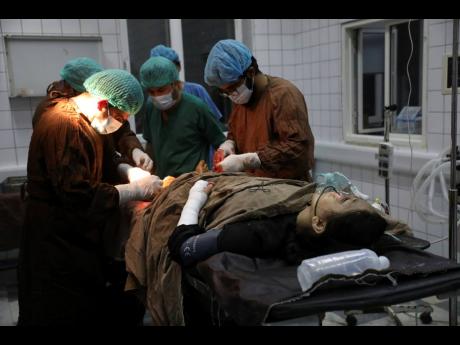 An Afghan school student is treated at a hospital after a bomb explosion near a school west of Kabul, Afghanistan, Saturday, May 8, 2021. 