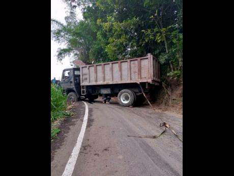 The driver of this truck reportedly had problems negotiating the Savage Pen road on Thursday. The steep, winding alternative to the breakaway-hit Gordon Town main road has been viewed with trepidation by some commuters.