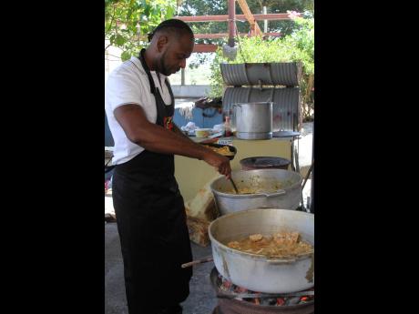 Craig Taylor is  seen cooking for single mothers on Mother’s Day at the Singh Quarry in May Pen, Clarendon.