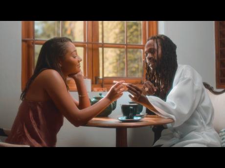 Female lead and model Natasha St Cyr (left) and Jesse Royal share tea and a joint in a scene from the video. 