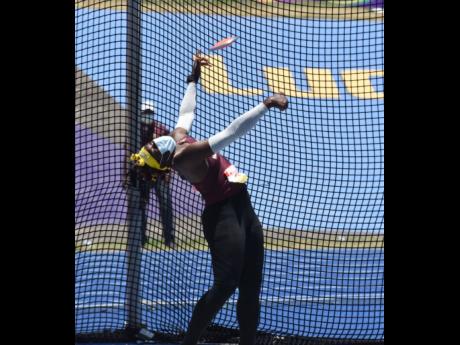 Holmwood Technical’s Cedricka Williams on her way to setting a new record of 47.04m in the Girls Class Two discus event at ISSA/GraceKennedy Boys and Girls’ Athletics Championships at the National Stadium yesterday. 