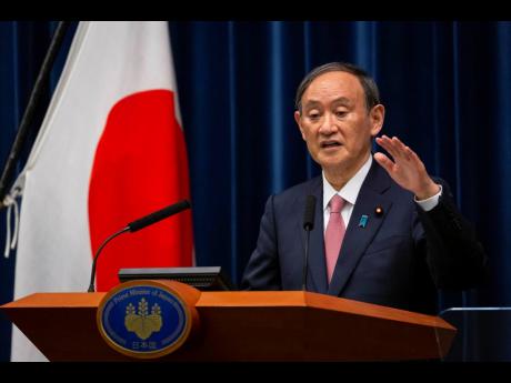 Japanese Prime Minister Yoshihide Suga speaks during a press conference at the prime minister’s official residence on Friday, May 14, in Tokyo. 