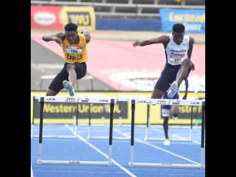 Jamaica College’s Javier Brown (right) clears the final hurdle on his way to a record breaking victory ahead of Excelsior High School’s Devontie Archer in the Class One Boys 400m hurdles at the ISSA/GraceKennedy Boys and Girls’ Athletics Championship