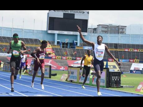 Jamaica College's Javain Brown (right) celebrates as he crosses the line for victory in the Class One Boys 400m final s ahead of Calabar High School's Jeremy Bembridge (left) and Holmwood Technical High School's Tahj Hamm (second left), who were second and