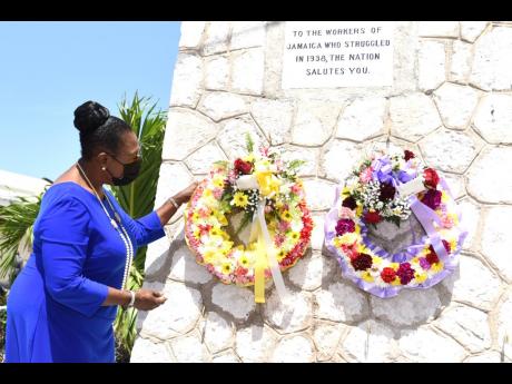 Minister of Culture, Gender, Entertainment and Sport Olivia Grange lays a wreath at the Aggie Bernard Monument in Kingston on Tuesday in remembrance of the Jamaican workers who led labour revolts in 1938.