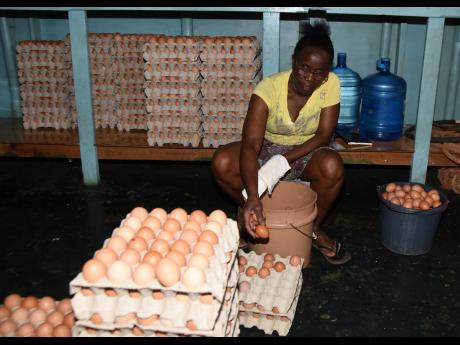 Lurline Bonner of N&D Grants Farm packs eggs for sale. 