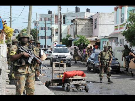 
In this May 27, 2010 Gleaner photo, members of the security forces on patrol in Tivoli Gardens in the aftermath of the May 10, 2010 operation.