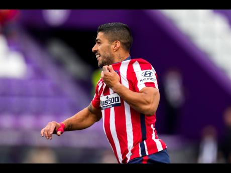 
Atletico Madrid’s Luis Suarez celebrates after scoring his side’s second goal during the Spanish La Liga match between Atletico Madrid and Valladolid at the Jose Zorrilla stadium in Valladolid, Spain, yesterday. Atletico won 2-1 to win the Spanish LaL
