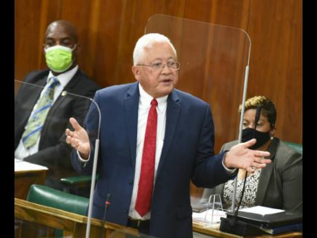 Justice Minister Delroy Chuck delivering his Sectoral Debate presentation in Parliament on May 4. Chuck said that expungment applications have been crowded out by the processing of police records for overseas-bound farm workers and employees in the BPO sec