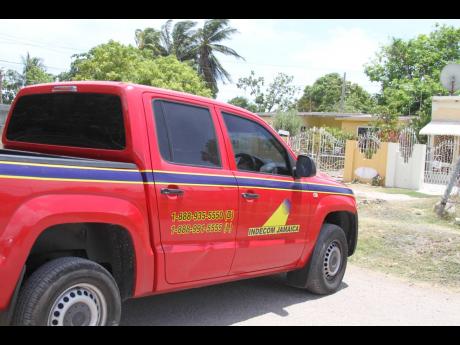 Personnel from the Independent Commission of Investigations processed the scene yesterday after a man was reportedly shot dead by his brother, a police officer, in Lionel Town, Clarendon.