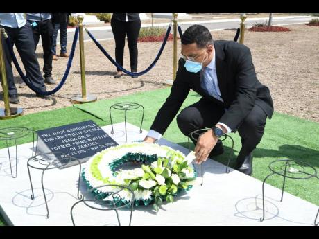 Prime Minister Andrew Holness paying tribute to former Prime Minister Edward Seaga at the National Heroes Park yesterday.