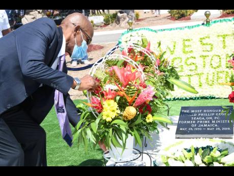 Christopher Seaga, son of the late Edward Seaga, lays wreath during a commemorative ceremony for the 91st anniversary of the birth of the former prime minister at the National Heroes Park in Kingston on Friday, May 28.