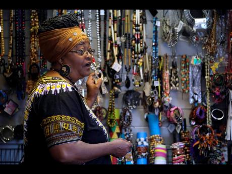 Billie Parker, owner of the Black Wall Street Market, displays some of the items she has for sale in Tulsa. Her establishment, in an underdeveloped and underserved section of the city, is a far cry from the booming city within a city that was Greenwood, wi