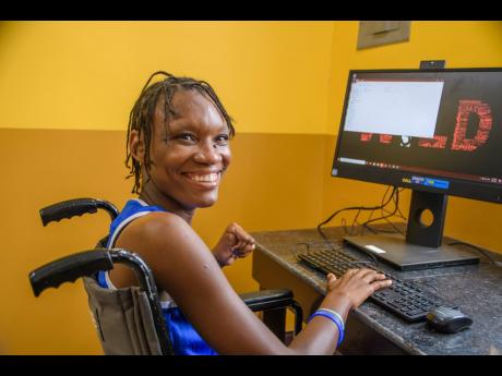 Shanice, a resident at MSC Jerusalem, enjoys time in the computer lab of the newly-constructed multi-purpose centre, which was funded by the Digicel Foundation. The centre will give the over 165 residents a safe, sanitised location for meetings, access to 